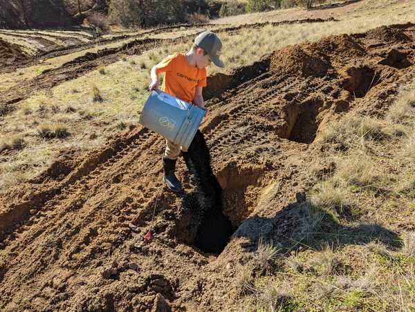 Chuck pouring biochar bucket